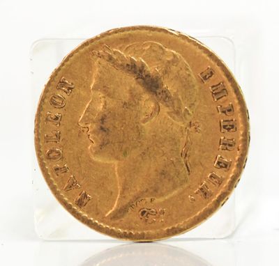 a close up of a gold coin on a clear surface