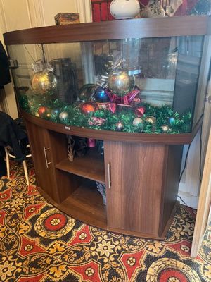 a fish tank with ornaments on it in the corner of a room
