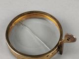 a close up of a gold colored ring with a metal handle