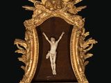 a gold framed picture of a person on a cross in a gold frame