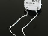 a close up of a tag on a chain on a table