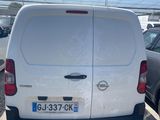the back end of a white van parked in a parking lot