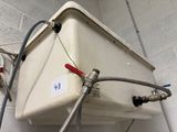 une photo d'un chauffe-eau auquel est raccordé un tuyau