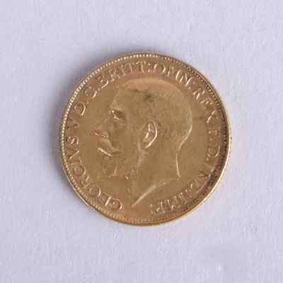 a gold coin with a picture of a man ' s face on it