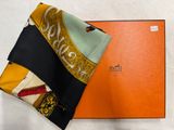 an orange box with a black and yellow scarf and a black and white scarf