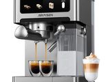 a silver coffee machine with two cups of coffee next to it