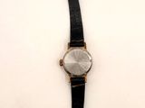 an image of a watch hanging on a hook on a wall