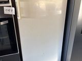 two refrigerators that are sitting next to each other in the kitchen
