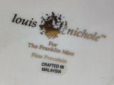 a white plate with a black and gold design on it