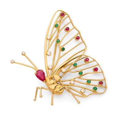 un gros plan d'une broche en forme de papillon ornée de pierres colorées