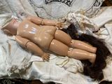 a doll that is laying down on a table