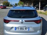 the rear end of a silver car parked in a parking lot