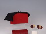 sunglasses, a wallet, and other items are laid out on a white surface