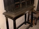 a black cabinet with many drawers on it in a room