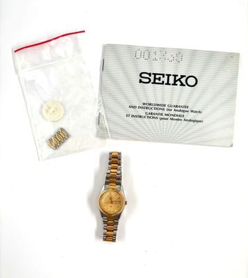 a watch that is sitting on a table next to a bag