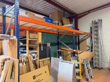 a room with a lot of boxes and ladders in it