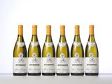 six bottles of white wine lined up in a row