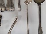 a lot of silver spoons and spoon spoons on the table