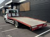 a flat bed truck parked in front of a building