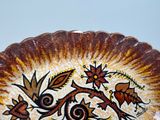 a plate with a decorative design on it sitting on a table