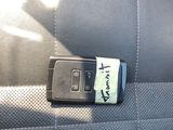 a cell phone attached to the seat belt of a car