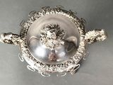 an antique silverplated bowl with a lion head on the lid