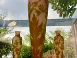 three vases sitting on a window sill in front of a window