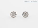 a pair of diamond earrings on a white background