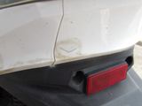 a close up of a red light on a white car