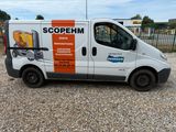 a van that is parked in the gravel