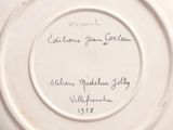 a white plate with writing on it on a table