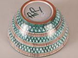 a bowl with a design on it sitting on a table