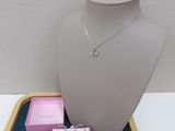 necklace and earrings on display on a tray in a display case