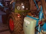 un tracteur auquel est raccordé un tuyau, dans un garage