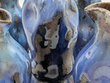 five blue vases sitting on top of a table