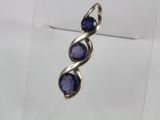 a close up of a pair of earrings with blue stones