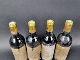 three bottles of wine are lined up on a black surface