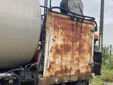 a rusted truck that is parked on the side of the road