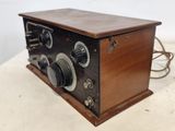 an old fashioned radio sitting on top of a wooden table