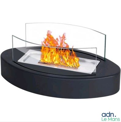 a close up of a fire in a glass bowl on top of a table