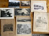 many pictures of old buildings on the table