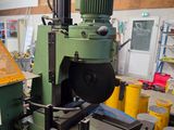 a machine that is working on a piece of wood