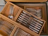 many forks and spoons in a box on the table