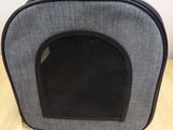 a cat carrier that is sitting on a wooden floor