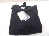a black bag with a tag on it sitting on a table