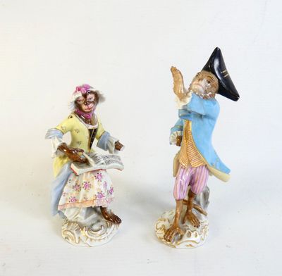 two figurines of a man and a woman on a scooter