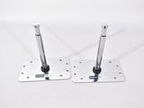 pair of chrome plated metal brackets with screws on a white surface