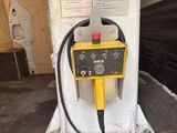 a yellow and black machine that is sitting in a garage