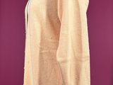a woman ' s sweater on a mannequin stand against a purple background