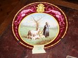 a plate with a picture of a man and a dog on it
